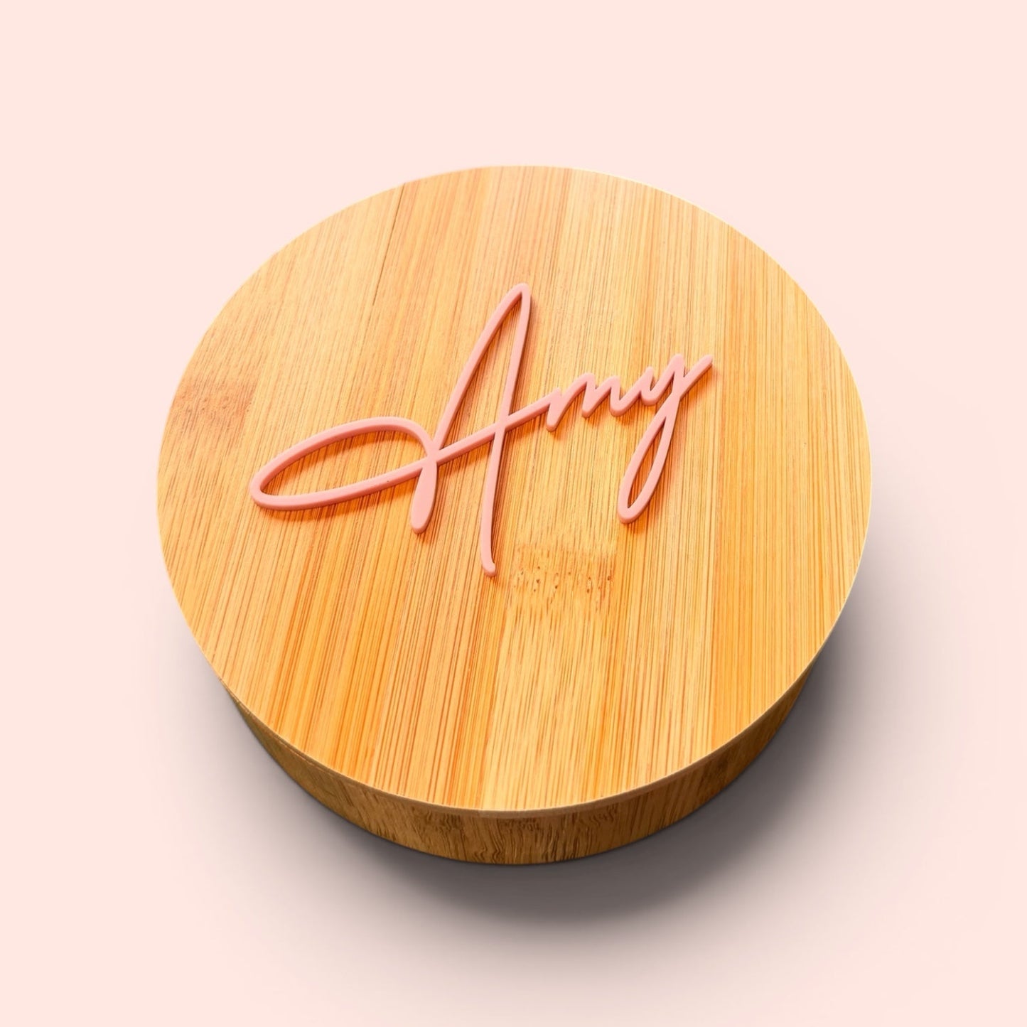 Bamboo jewellery box with 'Amy' engraved on a light pink background