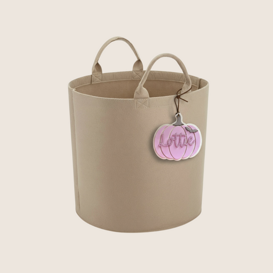 Beigefelt trug basket with handles on a beige background