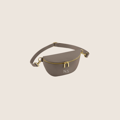 Taupe waist/Belt/Bum bag with gold accents on a beige background