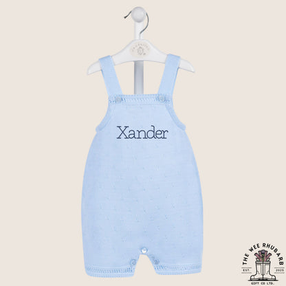 The Wee Rhubarb Gift Co Ltd pastel blue knitted baby romper with 'Xander' embroidered on the chest. Button fastenings.